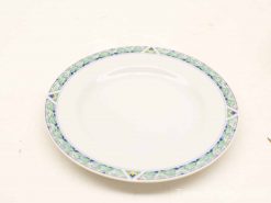 Elegant white ceramic plate with intricate blue and green leaf border, perfect for any occasion.