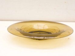 Elegant amber glass plate with intricate patterns for serving and decoration.