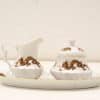 Elegant porcelain creamer and sugar bowl set with intricate dragon design for refined dining.