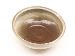 Handcrafted ceramic bowl with glossy brown interior and subtle matte exterior for serving or decoration.