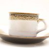 Elegant ceramic coffee cup and saucer set with rustic charm and modern simplicity.