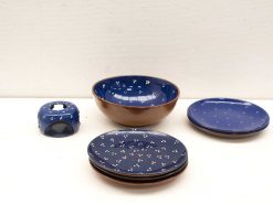 Charming blue and brown ceramic dinnerware set with playful white dots, perfect for any occasion.