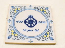 Ceramic tile commemorating 50 years of membership, featuring A, N, W, B emblem and floral design.