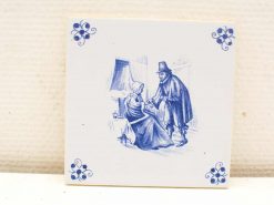 Vintage blue and white ceramic tile depicting an intimate conversation between a man and woman.