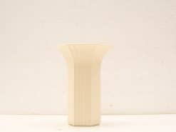 Elegant minimalist ceramic vase with a creamy-white finish and textured ribbed design.