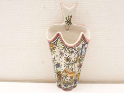 Charming vintage ceramic vase with floral patterns and a playful rabbit design.