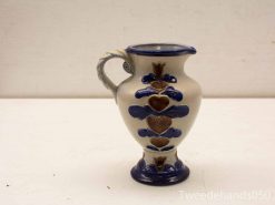 Elegant ceramic vase with intricate blue and gold designs, perfect for decor or flowers.