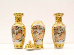 Decorative ceramic vases and lidded container with vibrant floral and animal motifs.