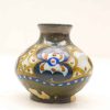 Elegant ceramic vase with vibrant floral patterns in green, blue, and earthy tones.