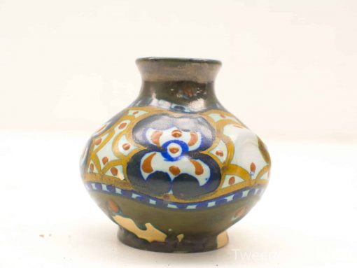 Elegant ceramic vase with vibrant floral patterns in green, blue, and earthy tones.