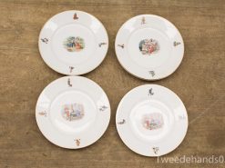 Elegant decorative plates with whimsical scenes and intricate illustrations for unique table settings.