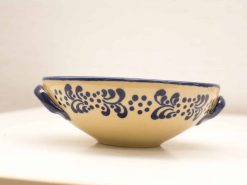 Elegant beige decorative bowl with navy blue accents and handles, perfect for serving or display.