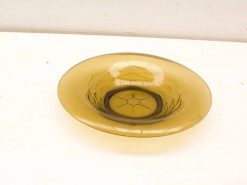 Elegant amber glass dish with intricate etching, perfect for decor or serving.