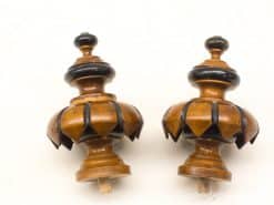 Elegant wooden finials with intricate petal carvings for stylish decor and architectural details.