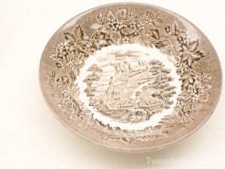 Intricate decorative ceramic plate featuring a nostalgic landscape and floral motifs.