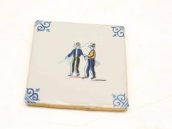 Antique-style decorative tile featuring vibrant figures with sparklers in a festive scene.