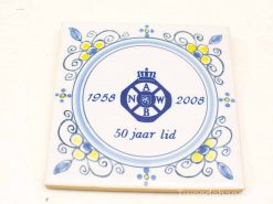 Ceramic tile celebrating 50 years of membership with blue and yellow floral designs.