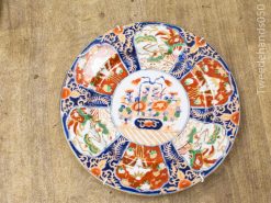 Vibrant vintage decorative plate featuring intricate floral patterns in bold colors. Perfect for collectors!