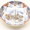 Serene decorative plate featuring a vibrant waterfront scene with charming buildings and boats.