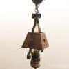 Rustic wood and metal hanging lamp with vintage charm, perfect for cozy interiors.