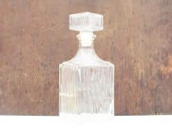 Elegant glass decanter with geometric stopper, perfect for serving whiskey or fine wine.