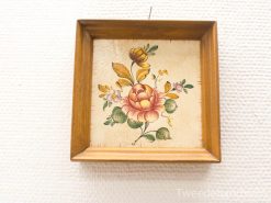 Vintage floral artwork featuring a pink rose in a rustic wooden frame. Perfect for home decor.