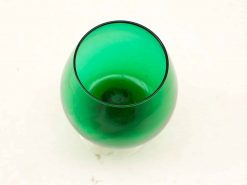 Elegant green glass goblet with a glossy finish and organic design, ideal for drinks or decor.