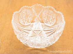 Elegant crystal bowl with intricate patterns, perfect for serving or decorative purposes.