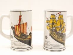 Ceramic beer steins featuring historic ship illustrations, perfect for collectors and maritime enthusiasts.