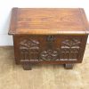 Elegant wooden chest with gothic carvings, perfect for storage and decoration in any room.