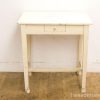 Rustic white wooden table with drawer, perfect for vintage-inspired interior design.