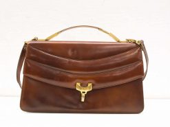 Timeless deep brown leather handbag with gold clasp and versatile carrying options.