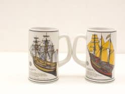 Vintage maritime beer mugs featuring detailed sailing ship designs, perfect for collectors.