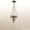 Elegant vintage hanging lamp with a glossy white shade and decorative metal accents.