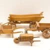 Miniature wooden carts and wheelbarrows showcasing vintage craftsmanship and rustic charm.