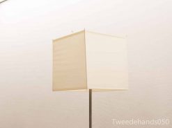 Elegant minimalist floor lamp with a cream square shade for modern interiors.