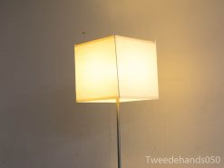 Sleek floor lamp with warm rectangular shade perfect for cozy modern interiors.