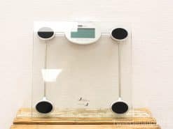 Sleek modern glass and metal digital bathroom scale with easy-to-read display and stability features.