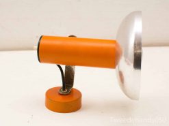 Stylish retro orange table lamp with metal shade, perfect for modern spaces and decor.