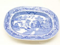 Decorative blue and white serving platter featuring a scenic landscape with pagodas and trees.