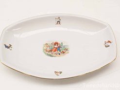 Vintage porcelain dish featuring playful children and animals, elegantly designed for decor or dining.