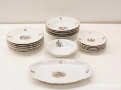 Elegant porcelain dinnerware set with historical motifs for special occasions and decorative display.