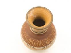 Elegant pottery vase with intricate designs in warm earthy tones, perfect for decor.