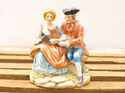 Charming porcelain figurine of a romantic couple, perfect for collectors and decor.