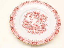 Vintage red and white floral plate with scalloped edges and gold accents for elegant décor.