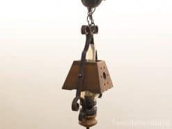 Rustic wood and metal hanging lamp with vintage charm, perfect for cozy interiors.