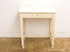 Rustic white wooden table with drawer, perfect for vintage-inspired interior design.