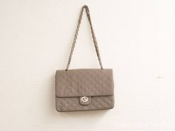 Elegant gray quilted leather handbag with silver clasp and chain strap for versatile styling.