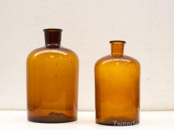 Vintage amber glass bottles set of two, perfect for decor or storage, exuding timeless elegance.