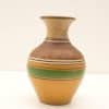 Elegant vintage vase in earthy tones with intricate gold and green designs.